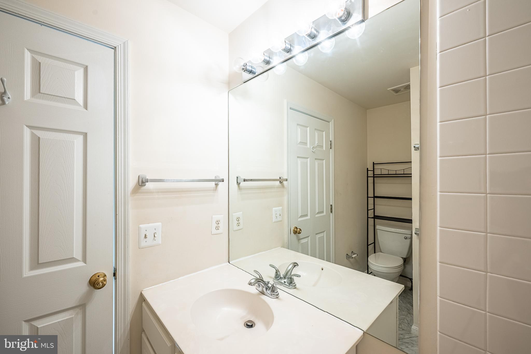 5920 Terrapin Place Alexandria, VA 22310 - Photo 46 of 67 a bathroom with a sink and a mirror