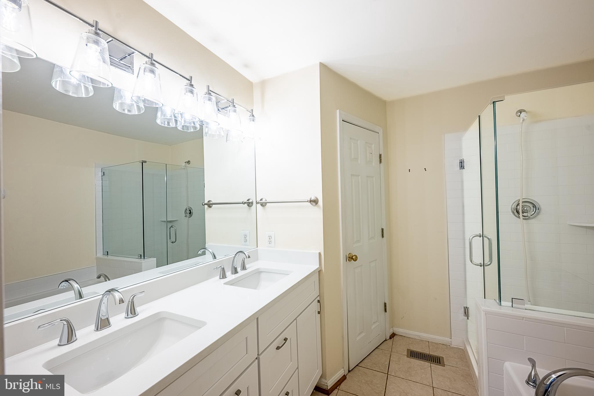 5920 Terrapin Place Alexandria, VA 22310 - Photo 48 of 67 a bathroom with a double vanity sink mirror and shower