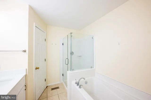 a view of a swimming pool with outdoor seating and plants