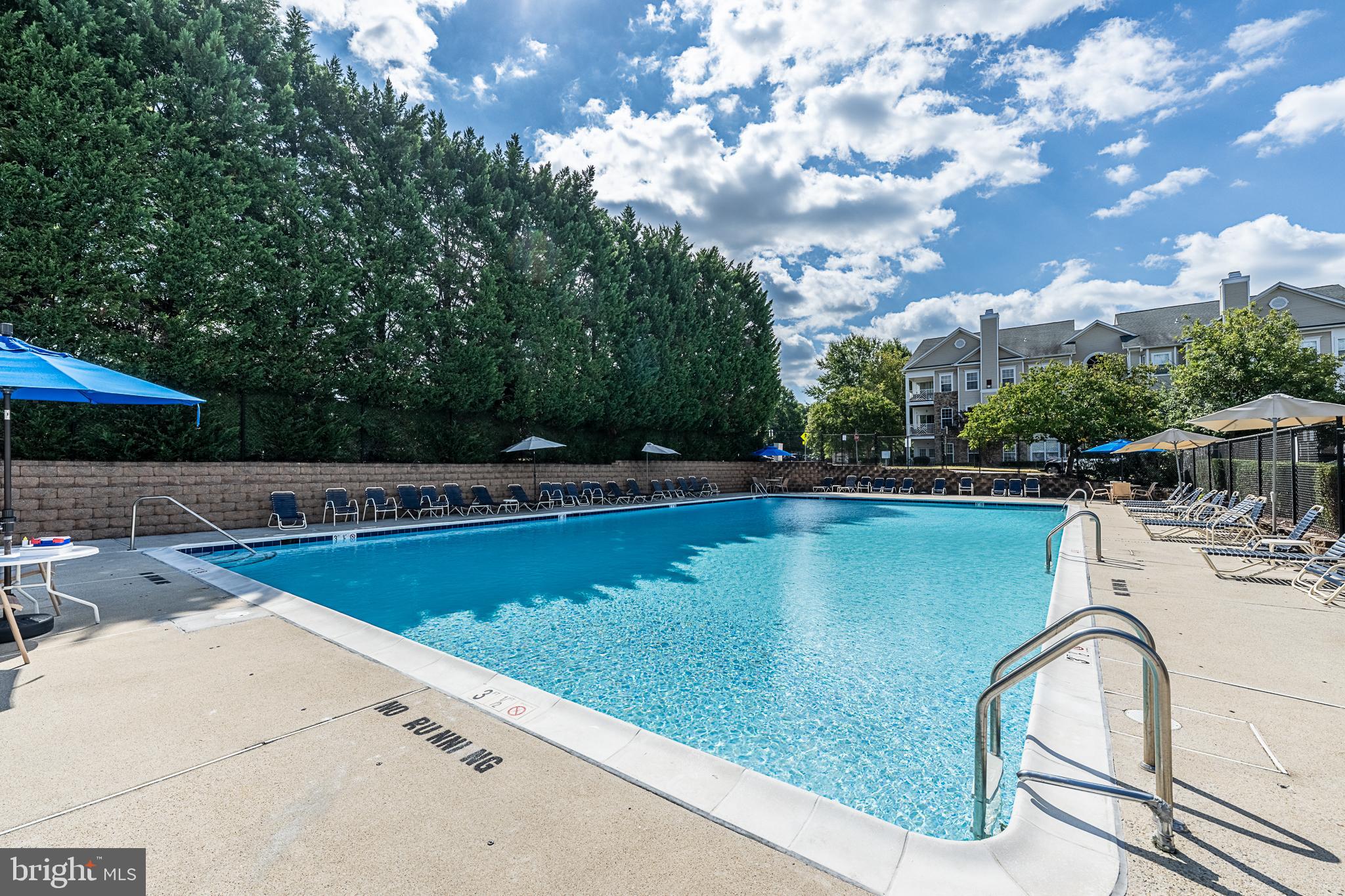 5920 Terrapin Place Alexandria, VA 22310 - Photo 67 of 67 a view of a swimming pool with a chair and tables in the backyard