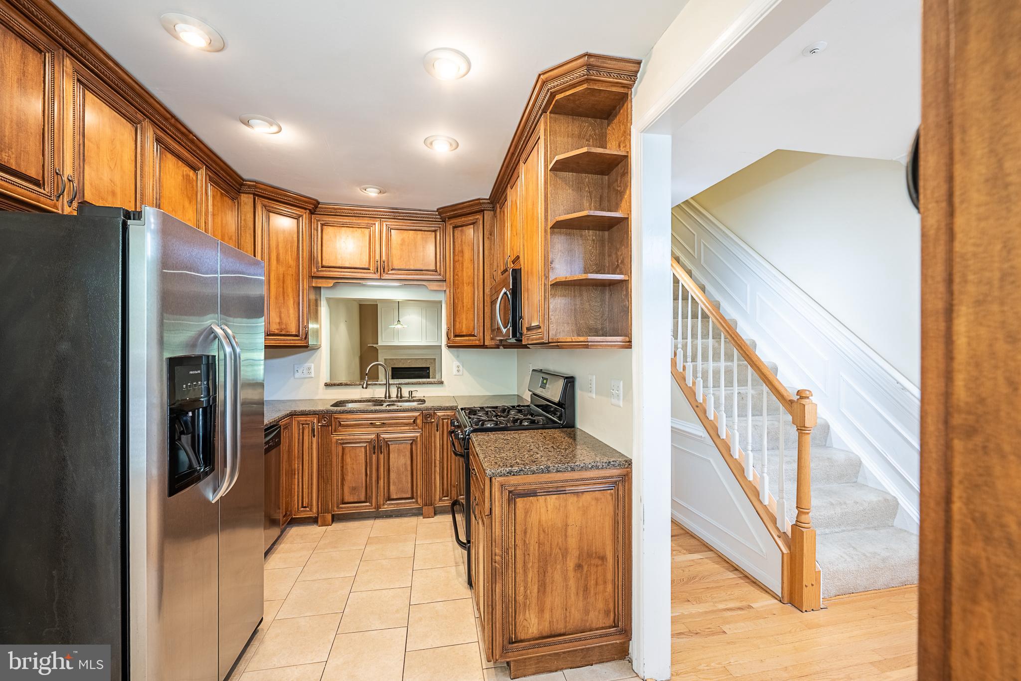 5920 Terrapin Place Alexandria, VA 22310 - Photo 10 of 67 a kitchen with stainless steel appliances granite countertop a stove a sink and a refrigerator