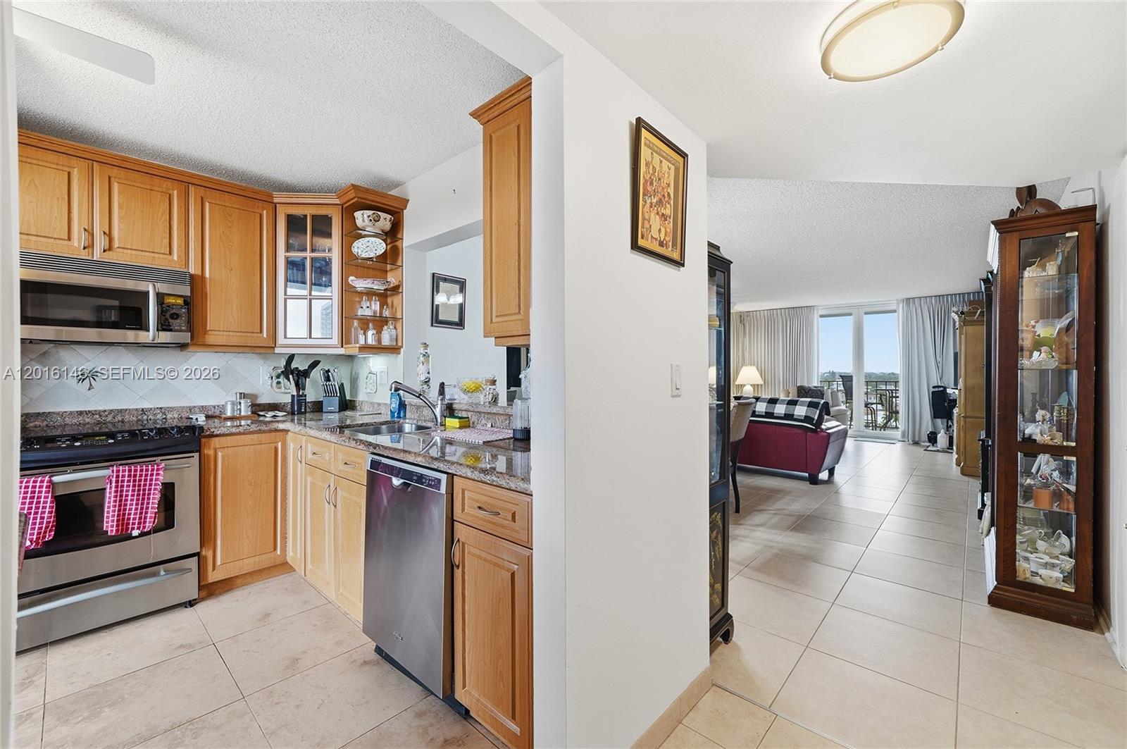 521 North Riverside Drive, Unit 606 Pompano Beach, FL 33062 - Photo 3 of 50 a kitchen with stainless steel appliances granite countertop a refrigerator and a stove top oven