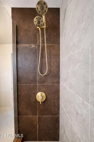 an empty room with wooden floor cabinet and windows