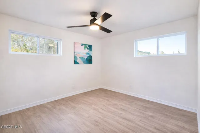 a bedroom with a large bed and a ceiling fan