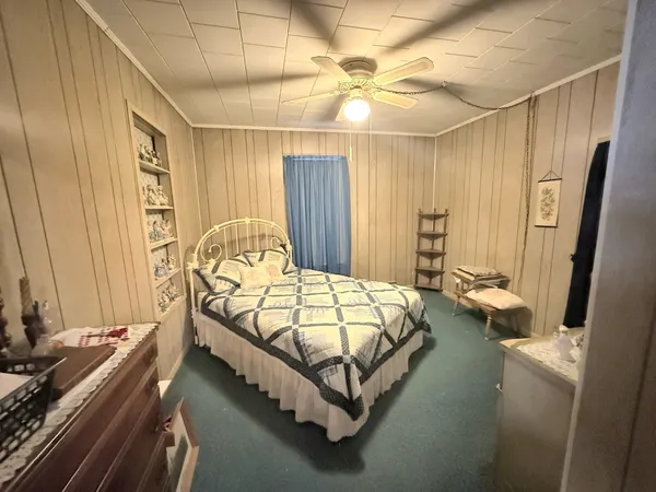 a bedroom with a bed and large mirror