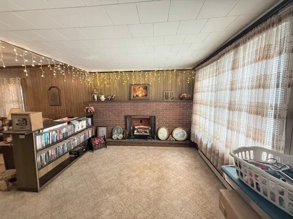 a view of a room with furniture and a fireplace