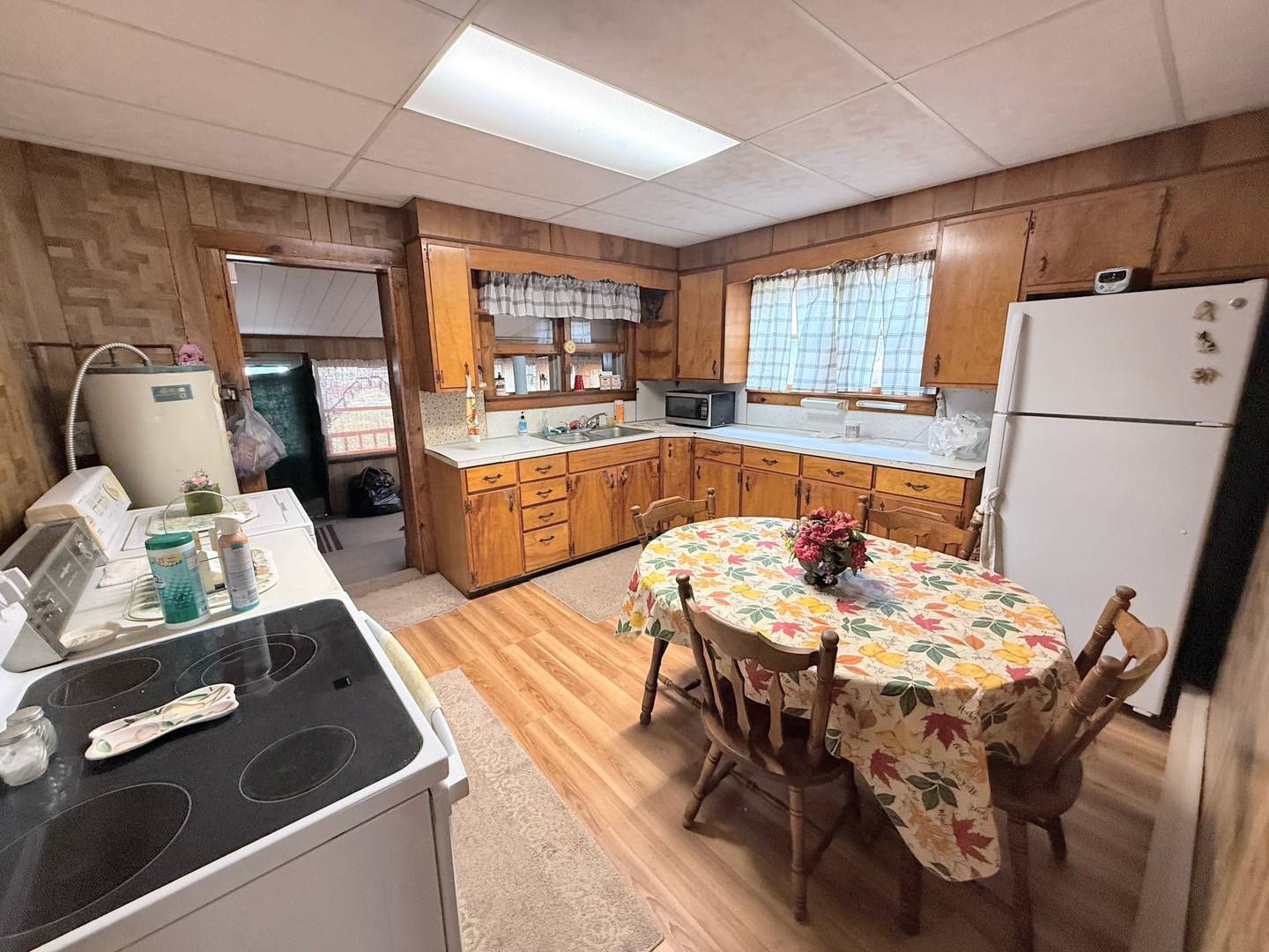 1421 West Maple Street Herrin, IL 62948 - Photo 6 of 15 a kitchen with stainless steel appliances granite countertop a stove a refrigerator a sink dishwasher a dining table and chairs with wooden floor