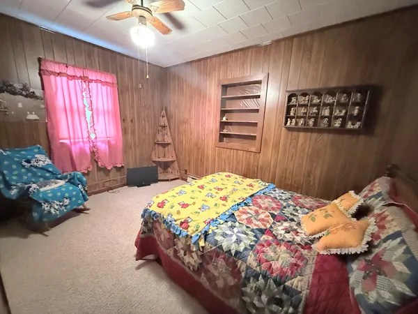 a bedroom with a bed and a chandelier