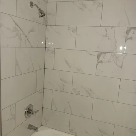 a white toilet sitting next to a bath tub