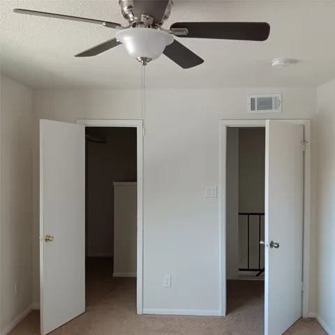 a view of a hallway to rooms