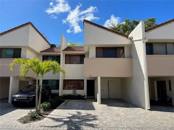a front view of a house with yard