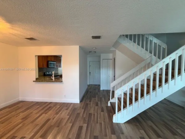 a view of an entryway with wooden floor