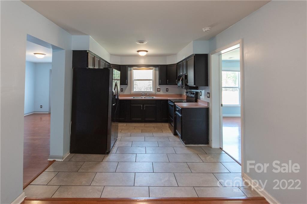 197 Ridge Point, Unit 6 Sylva, NC 28779 - Photo 4 of 13 a kitchen with stainless steel appliances granite countertop a refrigerator and a sink