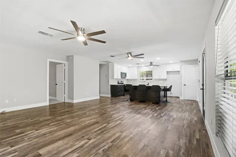 a living room with furniture and kitchen view