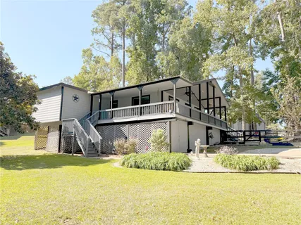 a front view of a house with swimming pool and sitting area