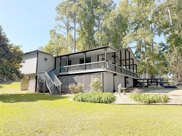 a front view of a house with swimming pool and sitting area