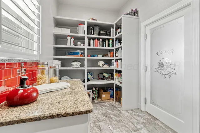 a view of a dining room with furniture a chandelier and wooden floor