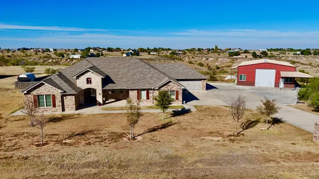 an aerial view of a house with a yard