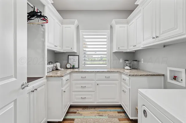 a kitchen with stainless steel appliances granite countertop a sink and cabinets