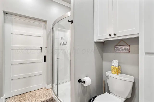 a view of a swimming pool with lawn chairs under an umbrella