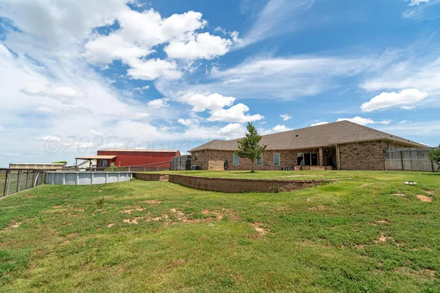 an aerial view of a house with a swimming pool