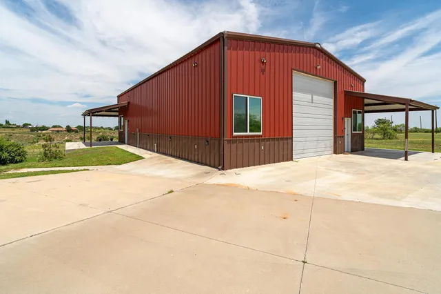 a view of a house with a tub and wooden fence