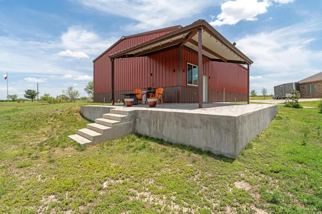 a view of a room that has a bed and a window