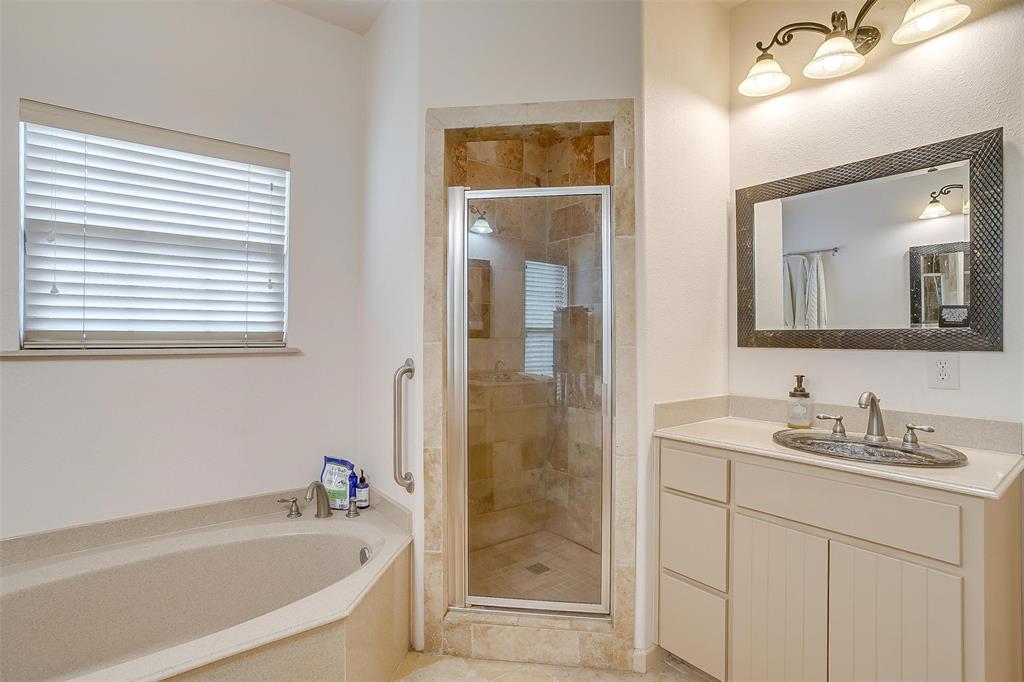 383 County Road 3672 Springtown, TX 76082 - Photo 14 of 39 Full bathroom with a stall shower, a garden tub, and vanity