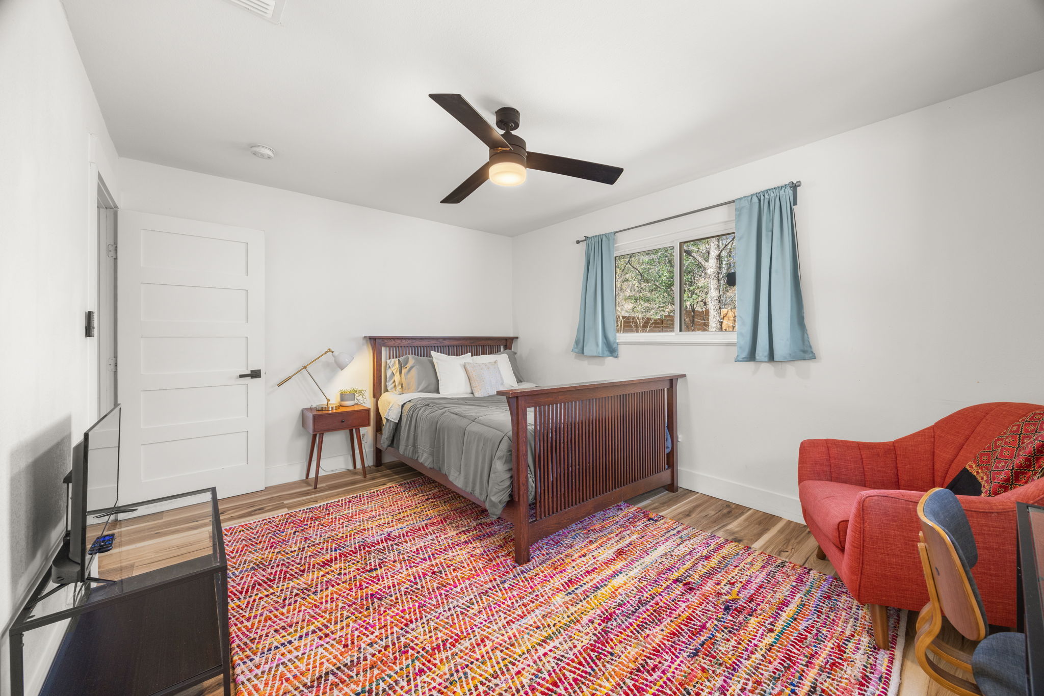 5002 Ledesma Road Austin, TX 78721 - Photo 13 of 32 a bedroom with a bed and wooden floor