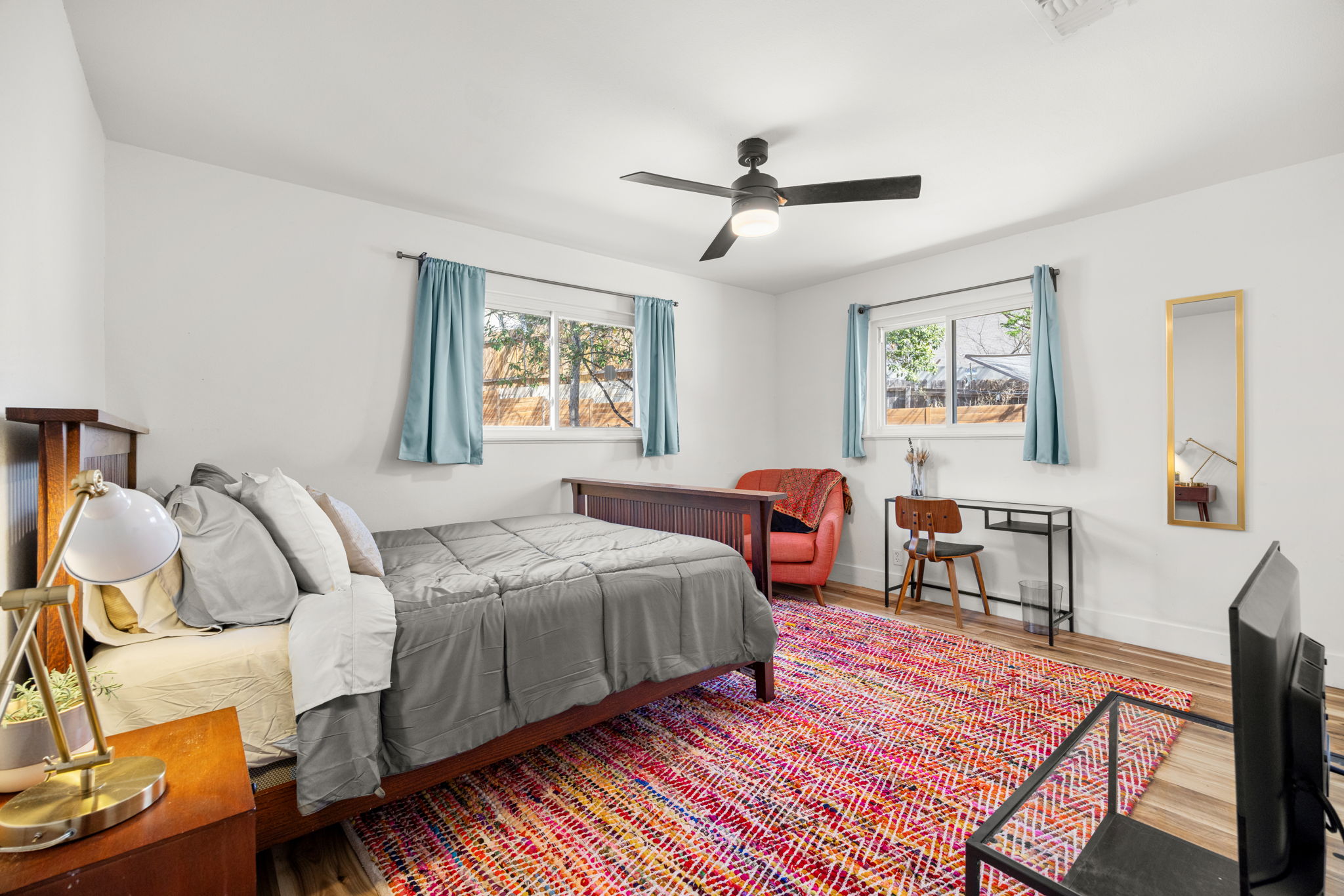 5002 Ledesma Road Austin, TX 78721 - Photo 14 of 32 a bedroom with a bed and wooden floor