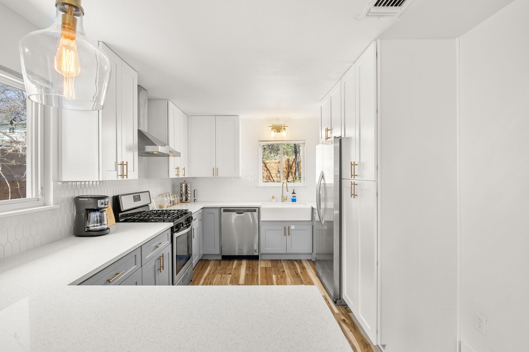 5002 Ledesma Road Austin, TX 78721 - Photo 4 of 32 a large white kitchen with stainless steel appliances