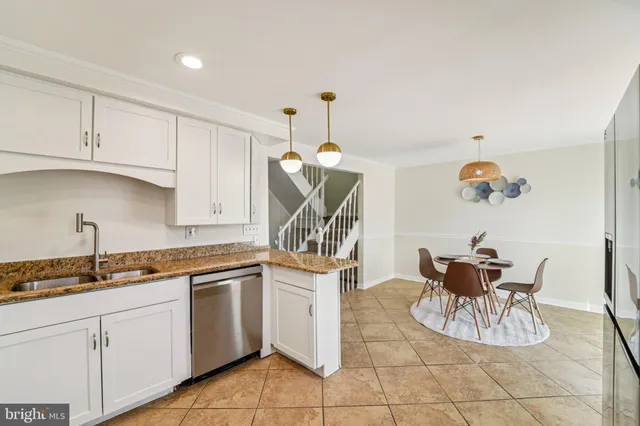 a kitchen with stainless steel appliances granite countertop a refrigerator sink and cabinets
