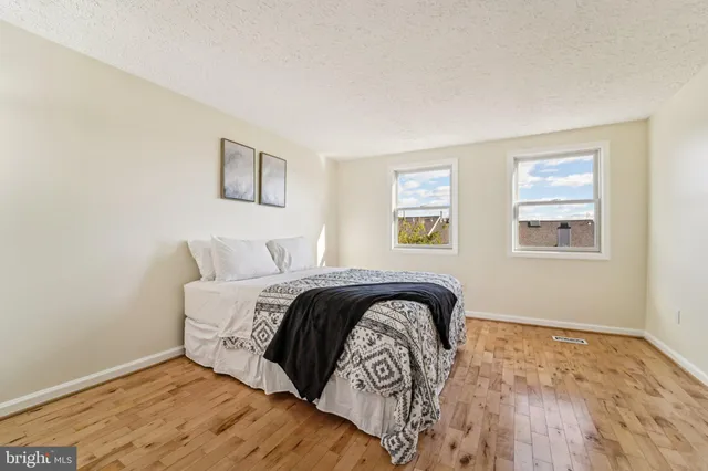 a view of a hallway with wooden floor and closet