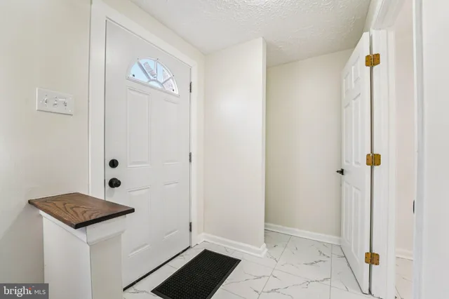 a picture of a bench in front of a wall