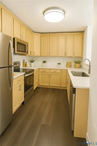 a kitchen with a sink stove and refrigerator
