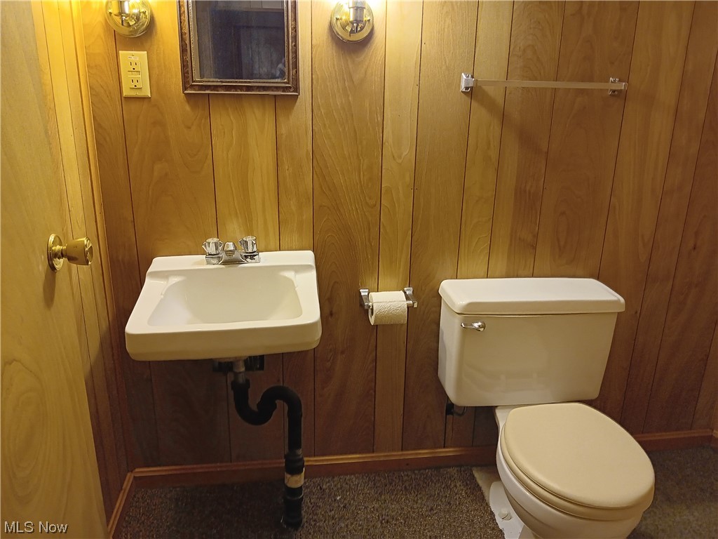 349 Jacobs Road Hubbard, OH 44425 - Photo 30 of 33 Bathroom with wooden walls, toilet, and sink