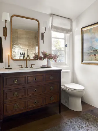 a bathroom with a toilet sink and mirror