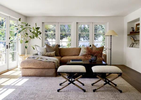 a living room with furniture and a floor to ceiling window