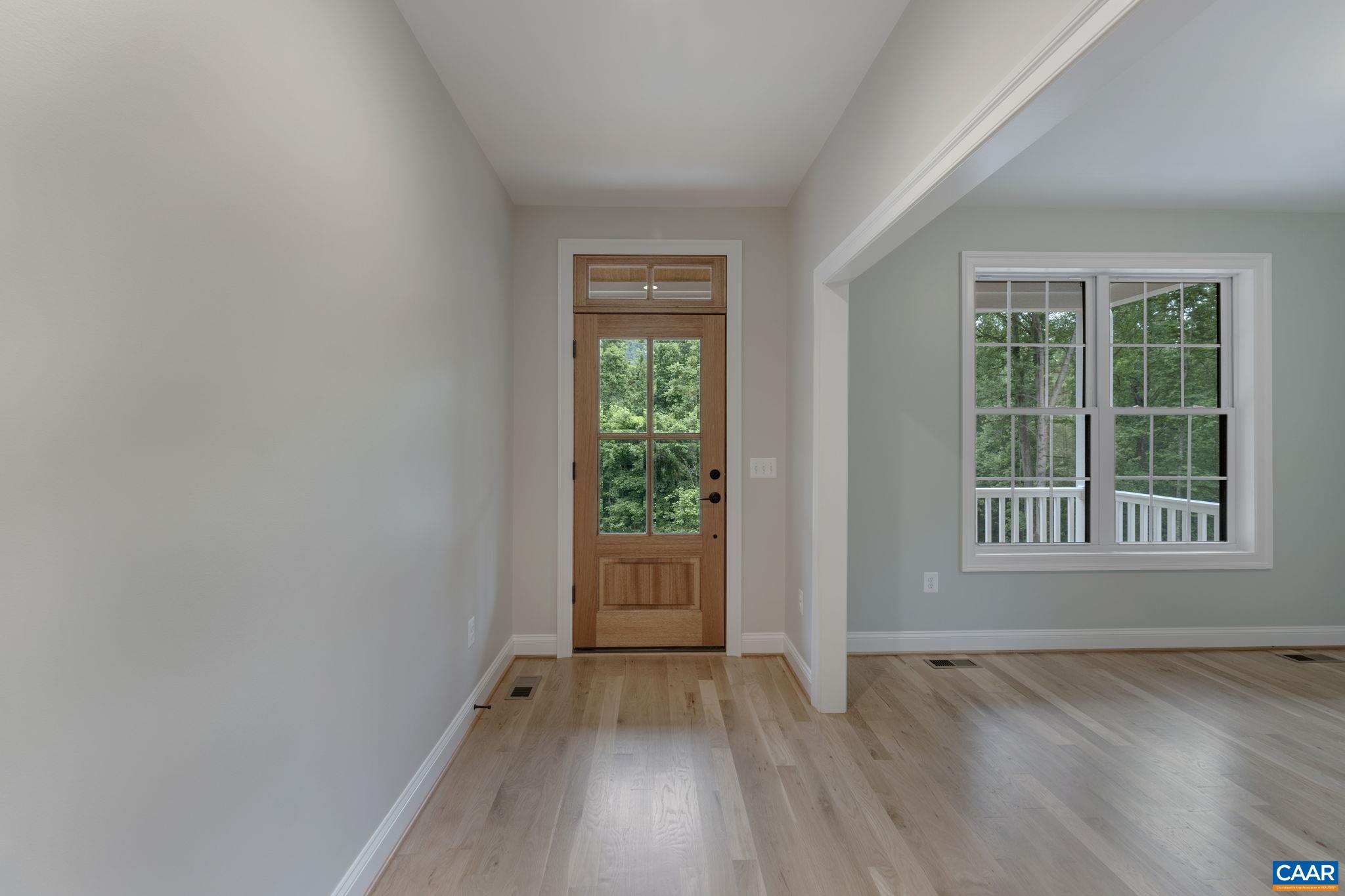 3 Lonicera Way Charlottesville, VA 22911 - Photo 14 of 31 an empty room with wooden floor and windows