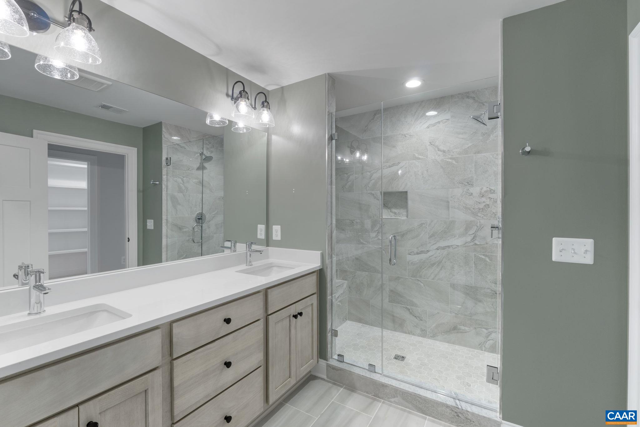 3 Lonicera Way Charlottesville, VA 22911 - Photo 16 of 31 a bathroom with a shower tub double vanity and a mirror