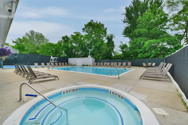 swimming pool view with a seating space