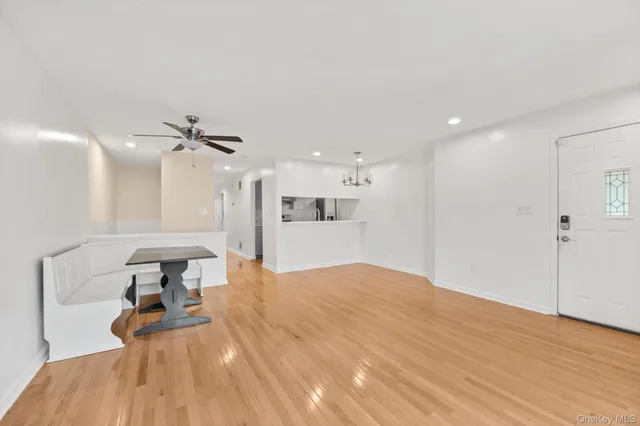 a view of a living room a kitchen and a wooden floor