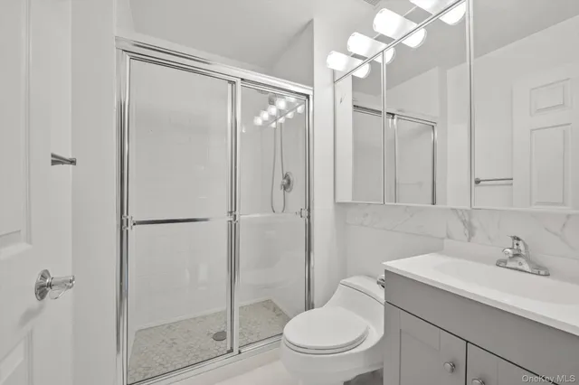 a bathroom with a toilet a sink and a shower