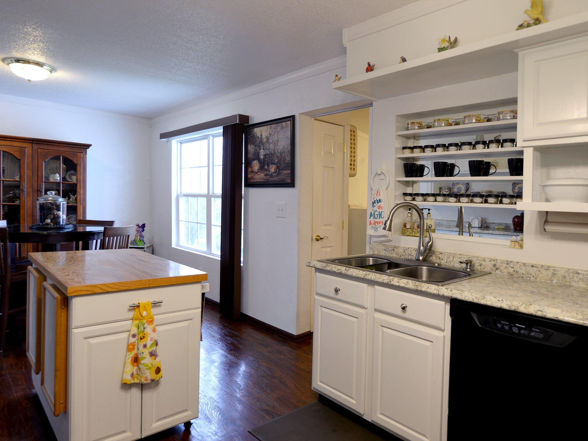 107 Salem Road Oak Ridge, TN 37830 - Photo 7 of 25 a kitchen with kitchen island granite countertop a sink a stove and wooden floors