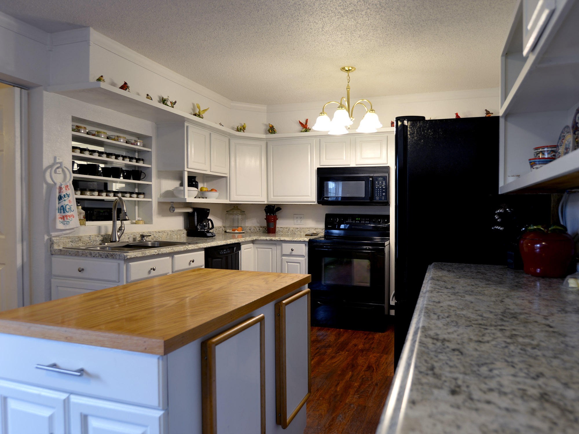 107 Salem Road Oak Ridge, TN 37830 - Photo 9 of 25 a kitchen with a refrigerator a stove top oven a sink and dishwasher