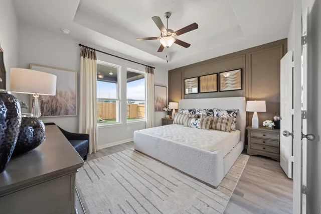 a spacious bedroom with a large bed and a window