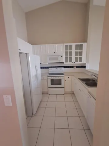 a kitchen with a stove a refrigerator and a sink
