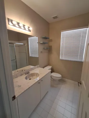 a bathroom with a sink a toilet and mirror
