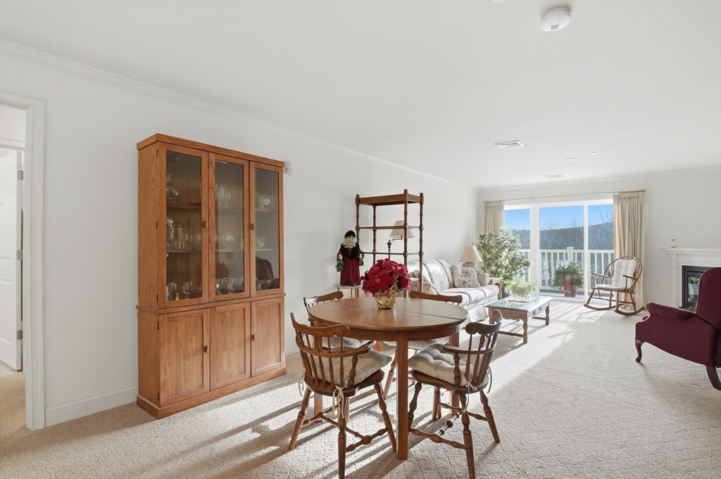 1818 Main Street, Unit 204 Holden, MA 01522 - Photo 8 of 30 a dining room with furniture and window