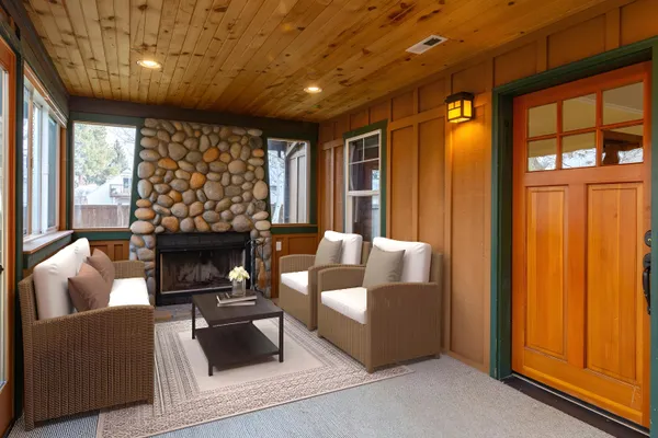 a living room with furniture a fireplace and a large window